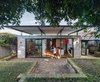The soaring canopy roof provides visual impact offering protection and shelter to the renewed indoor and outdoor living spaces to the rear of the home. Photo 2 of Enmore House modern home