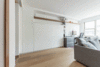 In the master bedroom section, he built a king-sized platform bed and matching nightstands. In the living room, the team devised a plan for a customized built-in wall unit, incorporating a queen-sized murphy bed and guest closet all conveniently and seamlessly hidden behind white lacquered plywood. Across the room, the GC installed a single walnut shelf running alongside the wall for entertainment equipment. Photo 6 of Gramercy Studio Renovation modern home
