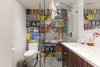 In the bathroom, they planned to change the footprint to allow for a larger, more accessible layout, and customize the adjoining closet to cater to “his and her” needs. The footprint was rotated 90 degrees to swap the shower and vanity, allowing for greater use of space overall. Photo 7 of Gramercy Studio Renovation modern home