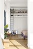 Another view of the bedroom, showcasing the high storage shelves accessible by a ladder. Photo 7 of A Greenwich Village Loft Gets a Makeover modern home