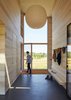Floor-to-ceiling glazing fills the entryway with light. Photo 18 of Orient House V modern home
