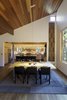 Modern home with Dining Room, Chair, Table, Lamps, Pendant Lighting, and Dark Hardwood Floor. Great room dining area and kitchen beyond. Photo 7 of The Frederick McKeehan Residence