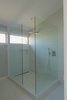 Modern home with Bath Room, Ceiling Lighting, Porcelain Tile Floor, Wall Mount Sink, Vessel Sink, Corner Shower, One Piece Toilet, Recessed Lighting, Full Shower, and Porcelain Tile Wall. Master bathroom Photo 17 of Bay View House