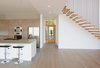 Modern home with Kitchen, Ice Maker, Wall Oven, Engineered Quartz Counter, Cooktops, Wood Cabinet, Light Hardwood Floor, Stone Slab Backsplashe, Dishwasher, Microwave, Drop In Sink, Refrigerator, Ceiling Lighting, Wine Cooler, and Recessed Lighting. Kitchen and entrance door Photo 9 of Bay View House