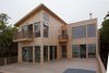 Modern home with Exterior, Shed RoofLine, Tile Roof Material, Beach House Building Type, Flat RoofLine, House Building Type, and Wood Siding Material. Deck view on a cloudy day Photo 14 of Bay View House