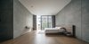 Modern home with Bedroom, Ceiling Lighting, Bed, Chair, Medium Hardwood Floor, Night Stands, Table Lighting, Rug Floor, and Shelves. Recessed lighting is strategically placed along the edges of this expansive, minimalist bedroom in Thailand. For master bedroom ceiling lighting ideas where a clean look is desired, recessed lighting makes a great option. Photo 7 of bAAn