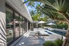 Modern home with Outdoor, Back Yard, Shrubs, Trees, Garden, Gardens, Hardscapes, Walkways, Lap Pools, Tubs, Shower, Standard Construction Pools, Tubs, Shower, Swimming Pools, Tubs, Shower, Concrete Patio, Porch, Deck, Tile Patio, Porch, Deck, Large Patio, Porch, Deck, Stone Patio, Porch, Deck, and Pavers Patio, Porch, Deck. The windows/doors open to allow both the interior and exterior spaces to work together or separately creating equal spaces and allowing the maximum amount of sunlight in. Photo 5 of Modernist Retreat