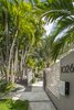 Modern home with Outdoor, Garden, Gardens, Trees, Front Yard, Walkways, Hardscapes, Vertical Fences, Wall, Concrete Patio, Porch, Deck, Grass, and Metal Fences, Wall. Clean lines, with the design being more sculptural than utilitarian. Design being a priority but privacy was a must. Photo 2 of Modernist Retreat