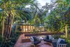 Modern home with Outdoor, Back Yard, Garden, Gardens, Walkways, Hardscapes, Shrubs, Trees, Large Pools, Tubs, Shower, Plunge Pools, Tubs, Shower, Swimming Pools, Tubs, Shower, Standard Construction Pools, Tubs, Shower, Pavers Patio, Porch, Deck, Landscape Lighting, Lap Pools, Tubs, Shower, and Large Patio, Porch, Deck. The canopy of the palms help frame the Master Suite and provide privacy from the neighbors. The different levels of the garden add interest and help define spaces within the property Photo 17 of Key West Classic