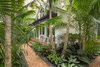 Modern home with Outdoor, Back Yard, Garden, Trees, Shrubs, Hardscapes, Gardens, Large Patio, Porch, Deck, Landscape Lighting, Pavers Patio, Porch, Deck, and Walkways. Groupings of plantings help to keep the garden looking open and modern while still having a tropical feel. Photo 15 of Key West Classic