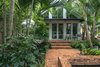 Modern home with Outdoor, Garden, Shrubs, Trees, Gardens, Back Yard, Walkways, Hardscapes, Standard Construction Pools, Tubs, Shower, Swimming Pools, Tubs, Shower, Lap Pools, Tubs, Shower, Large Pools, Tubs, Shower, Pavers Patio, Porch, Deck, Plunge Pools, Tubs, Shower, Large Patio, Porch, Deck, and Landscape Lighting. The canopy of the palms help frame the Master Suite and provide privacy from the neighbors. The different levels of the garden add interest and help define spaces. Photo 16 of Key West Classic