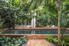 Modern home with Outdoor, Back Yard, Garden, Trees, Shrubs, Gardens, Hardscapes, Walkways, Large Pools, Tubs, Shower, Plunge Pools, Tubs, Shower, Swimming Pools, Tubs, Shower, Lap Pools, Tubs, Shower, Standard Construction Pools, Tubs, Shower, Large Patio, Porch, Deck, Pavers Patio, Porch, Deck, and Landscape Lighting. The Old Chicago Brick adds to the feel of 'Old Key West' and the raised coping of the pool helps separate the guesthouse from the main house. Photo 14 of Key West Classic