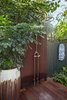 Modern home with Outdoor, Garden, Side Yard, Gardens, Walkways, Hardscapes, Wood Patio, Porch, Deck, Shrubs, Decking Patio, Porch, Deck, and Landscape Lighting. An outdoor shower was placed near the pool but tucked away to allow some privacy for those using it. Photo 8 of Von Phister