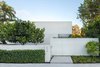 Modern home with Outdoor, Garden, Front Yard, Trees, Shrubs, Hardscapes, Horizontal Fences, Wall, Concrete Patio, Porch, Deck, and Landscape Lighting. Entry way to a modern, contemporary Key West home. Clean lines, planting was done with minimal species and in groupings. Photo of Tropical Minimal