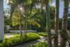 Modern home with Outdoor, Side Yard, Garden, Back Yard, Trees, Shrubs, Grass, Hardscapes, Standard Construction Pools, Tubs, Shower, Plunge Pools, Tubs, Shower, Small Patio, Porch, Deck, Small Pools, Tubs, Shower, Walkways, Concrete Patio, Porch, Deck, and Landscape Lighting. A swimming pool was a priority for this tropical retreat. Poured in place concrete is used throughout the property both as a function and design element. Photo 6 of Tropical Minimal