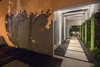 Modern home with Outdoor, Front Yard, Walkways, Side Yard, Hardscapes, Trees, Concrete Patio, Porch, Deck, Small Patio, Porch, Deck, Pavers Patio, Porch, Deck, and Landscape Lighting. Lighting is used to create drama, as well as, safety to this modernist retreat. Photo 11 of Tropical Minimal