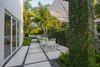 Modern home with Outdoor, Side Yard, Garden, Trees, Gardens, Shrubs, Hardscapes, Walkways, Concrete Patio, Porch, Deck, Small Patio, Porch, Deck, and Landscape Lighting. Indoor/outdoor living is a must in Key West. The main design philosophy of the overall design was to create areas outside that acted as their own special spaces and were an extension of the inside. Photo 5 of Tropical Minimal