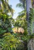 Modern home with Outdoor, Garden, Side Yard, Trees, Shrubs, Hardscapes, Walkways, Gardens, Small Patio, Porch, Deck, Pavers Patio, Porch, Deck, and Landscape Lighting. Different species of tropical plants were used to give added interest in color and texture throughout the garden. Photo 6 of Fred's Garden