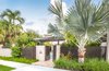 Modern home with Outdoor, Shrubs, Front Yard, Trees, Grass, Hardscapes, Small Pools, Tubs, Shower, Walkways, Swimming Pools, Tubs, Shower, Standard Construction Pools, Tubs, Shower, Large Patio, Porch, Deck, Pavers Patio, Porch, Deck, Landscape Lighting, Metal Fences, Wall, and Garden. Privacy was an important factor for the clients but the fencing had to be kept under a certain height due to regulations in Old Town Key West. Powder-Coated aluminum was used so the visual weight of the fence didn't feel too heavy. Dense tropical planting was strategically placed to help maintain privacy. A modern postbox and street numbers were used in keeping with the style of the property. Photo of Key West Modern