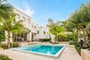 Modern home with Outdoor, Garden, Front Yard, Shrubs, Trees, Hardscapes, Raised Planters, Walkways, Gardens, Small Pools, Tubs, Shower, Standard Construction Pools, Tubs, Shower, Swimming Pools, Tubs, Shower, Large Patio, Porch, Deck, Pavers Patio, Porch, Deck, and Landscape Lighting. It's all about the details and the infinity edge of the pool was a priority for the home owners. The minimal color palette, clean lines and tropical planting make this the resort home of their dreams. Photo 7 of Key West Modern