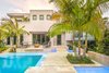 Modern home with Outdoor, Front Yard, Shrubs, Trees, Grass, Walkways, Swimming Pools, Tubs, Shower, Hardscapes, Small Pools, Tubs, Shower, Standard Construction Pools, Tubs, Shower, Large Patio, Porch, Deck, Pavers Patio, Porch, Deck, Landscape Lighting, and Garden. A clean, modern dramatic entrance was one of the most important elements for the clients when designing their Key West Retreat. Photo 5 of Key West Modern