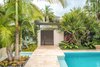 Modern home with Outdoor, Side Yard, Shrubs, Hardscapes, Back Yard, Trees, Walkways, Swimming Pools, Tubs, Shower, Standard Construction Pools, Tubs, Shower, Gardens, Large Patio, Porch, Deck, Small Pools, Tubs, Shower, Pavers Patio, Porch, Deck, Horizontal Fences, Wall, Landscape Lighting, and Garden. Lush tropical planting not only helps create the Tropical Resort feel that the clients wanted but it also helps for privacy. Powder-coated aluminum was used for the gate so it had less of a visual weight and didn't feel 'heavy'. Photo 6 of Key West Modern