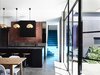 Modern home with Kitchen, Concrete Floor, Brick Backsplashe, and Pendant Lighting. The architects highlighted, rather than hid, the contrasts between the old construction and new. For instance, the backdrop in the new kitchen is the former exterior red brick wall. Photo 4 of Elwood House