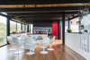 Modern home with Dining Room, Medium Hardwood Floor, Table, and Chair. In a midcentury home in Victoria, Australia, an interior designer embraces color and a connection to the outdoors. Photo 2 of Peninsula Residence