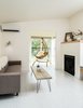 Modern home with Living Room, Sofa, Coffee Tables, Light Hardwood Floor, Chair, Gas Burning Fireplace, and Wall Lighting. A lodge with two seating areas. Photo 3 of The Lodges on Vashon