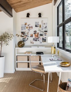 The second-floor mezzanine of this renovated home by Mowery Marsh Architects now hosts a spacious home office that looks out onto the roof terrace. A design departure from the photo above, this bright, airy space is full of home office ideas for her. It's feminine-chic with just-right touches of gold and natural materials. 