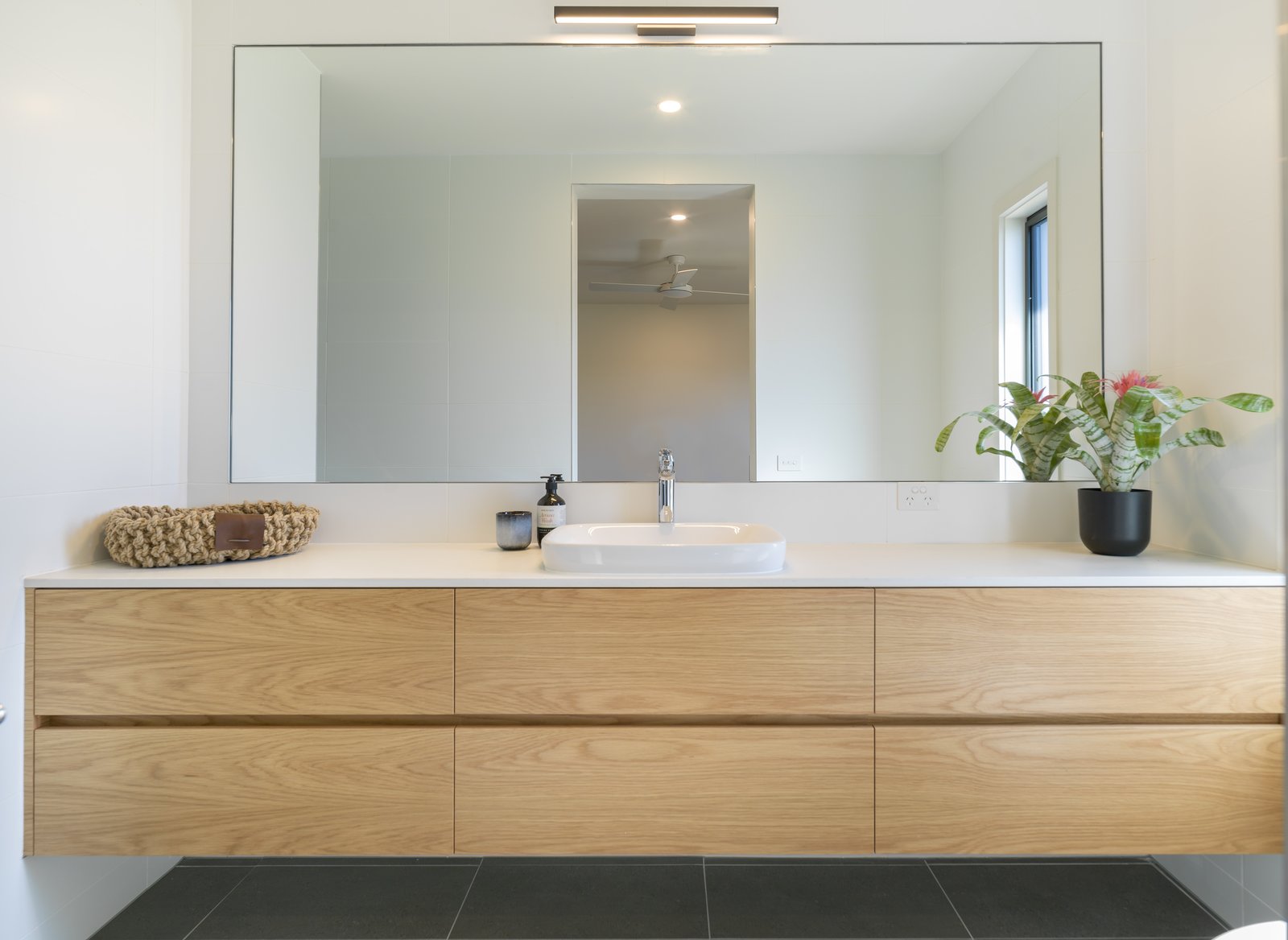 Four-star plumbing fittings, a 10,000-litre tank for rainwater harvesting, and an Eco Hot Water Heat Pump from Sanden promote water and energy savings throughout the home.