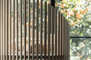 Space between the wood dowels allows for connection between cat and owner, while still giving the cat a sense of enclosure.