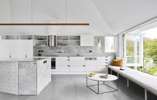 Now, the new kitchen is ideal for cooking big meals and socializing. White cabinetry and Carrara marble counters lend an airy feel.