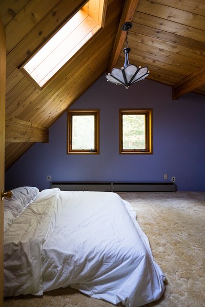 Before: Purple walls, fluffy carpeting, and a boring chandelier would have to go, but the pine paneling stayed.