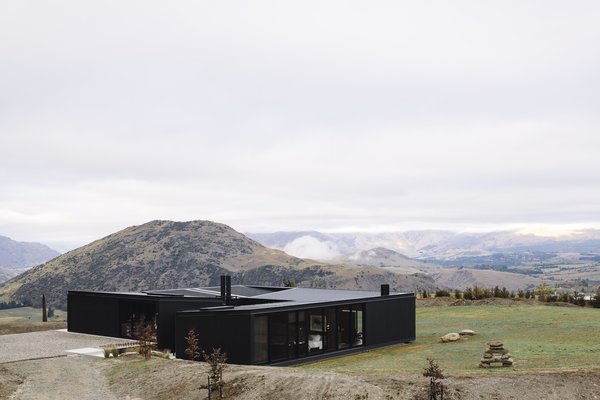 Entry to the house is accessed via the gravel arrival court. A floating ledge bridges to the front door, which is located in a "glazed volume set between two of the buildings," said the architects.