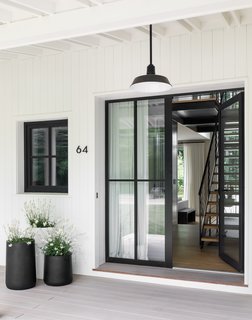 An exterior light from Barn Light Electric illuminates the entry.