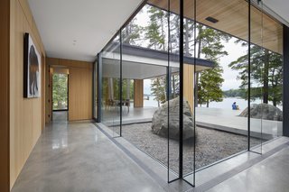 The frames around the glass were kept minimal so as to put the attention on the outdoors. The polished concrete flooring inside merges easily with the courtyard to encourage a sense of indoor/outdoor flow.