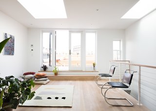 The firm also created a rooftop patio tucked behind the exterior cornice parapet. The rug is by Cold Picnic.