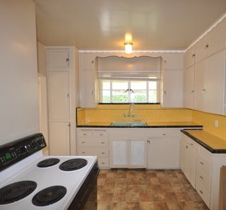 Before: Three tiny rooms at the back of the house, including the kitchen, were opened up and reconfigured to create better connection and circulation between the kitchen and dining room. 