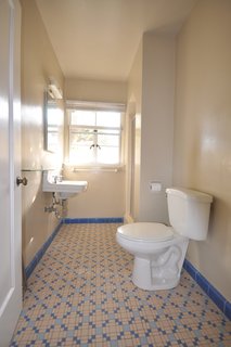 Before: The couple kept the sink, basic layout of fixtures, and window in the guest bath.