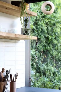 Indoor and outdoor spaces merge. The stacked wall tile is from the Marcato Craftsman Series and the floating shelves are rough-sawn Douglas fir.