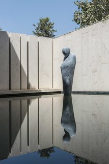 "A long search for an appropriate emotion for the water body ended in the commissioning of a life-size sculpture of a pensive monk in Beslana stone, gingerly poised on the water’s surface as if levitating," say the architects.