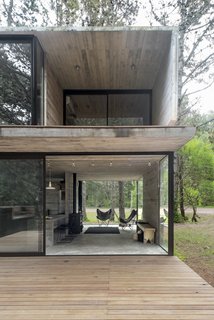 "When we designed this floor plan, we aimed at making it feel like an indoor space—sheltered by the roof and the windows—but at the same time, somewhere in between in a continuum with the outside," said the firm.