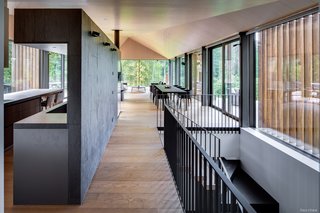 Screens composed of vertical wood slats discourage interior overheating and are a decorative feature.