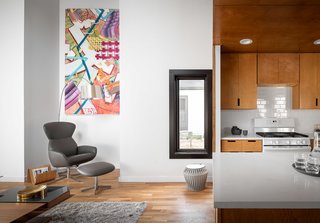 A niche makes for a comfortable reading spot in the living room. All of the flooring is white oak.