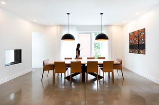 When a maple tree had to be cut down on the property in order to let in more light to the building, the wood was repurposed for the dining room table, stair tread, and kitchen island. The chairs are from The Bay.