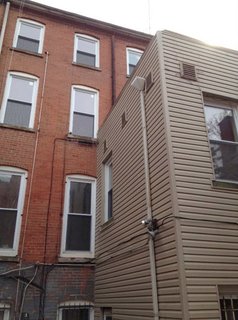 Before: a view of the exterior of the rear extension and its lackluster siding.