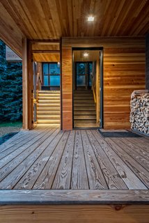 The stairs on the left lead up to the screened-in porch, while the door on the right accesses two bedrooms and a bath, with stairs leading up to the second-floor living spaces.