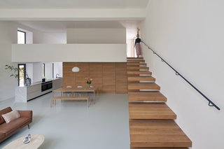 The high ceilings in the original gymnasium enabled the architects to introduce a mezzanine floor into the volume to foster privacy for the bedrooms. The finished home is 2,475 square feet.