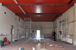 Before: the existing building is a ground-floor gymnasium with an adjacent hallway and storage area, all of which was once part of an early-20th century school complex that is now being developed into individual homes.